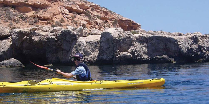 Young boy kayaking in Gozo, Malta