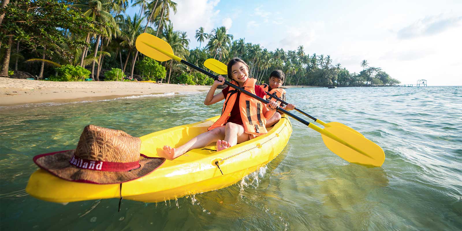Siblings kayaking in Phuket, Thailand