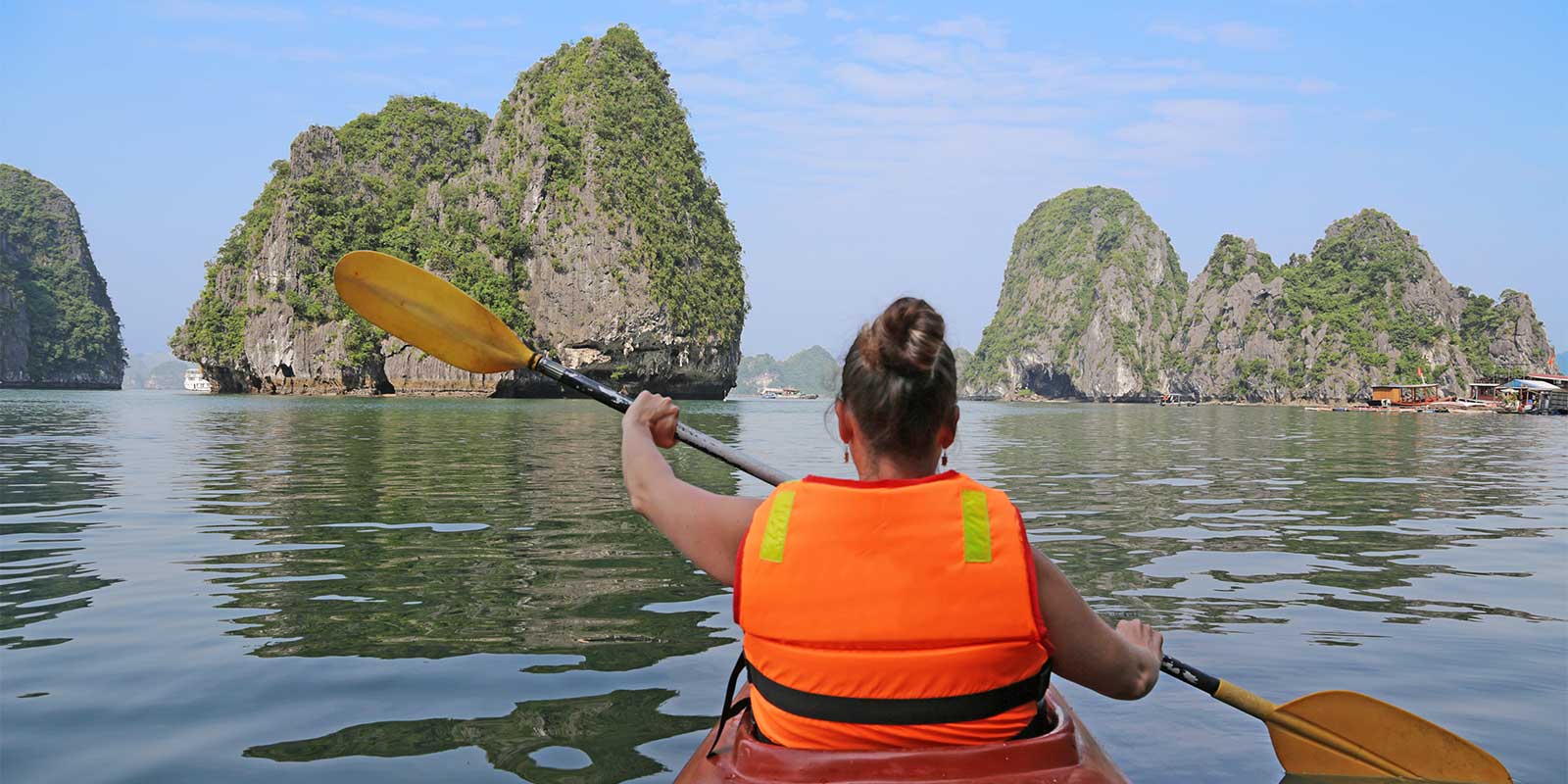 Young girl kayaking in Halong Bay Vietnam