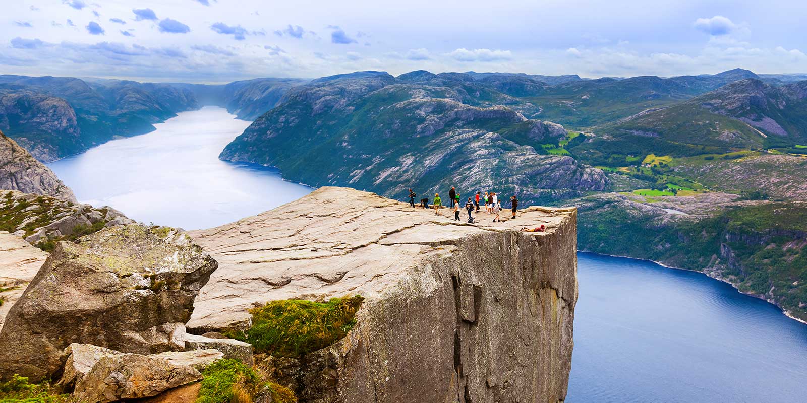 A group survey Lysefjorden in Norway from Prekestolen, known as Pulpit Rock.