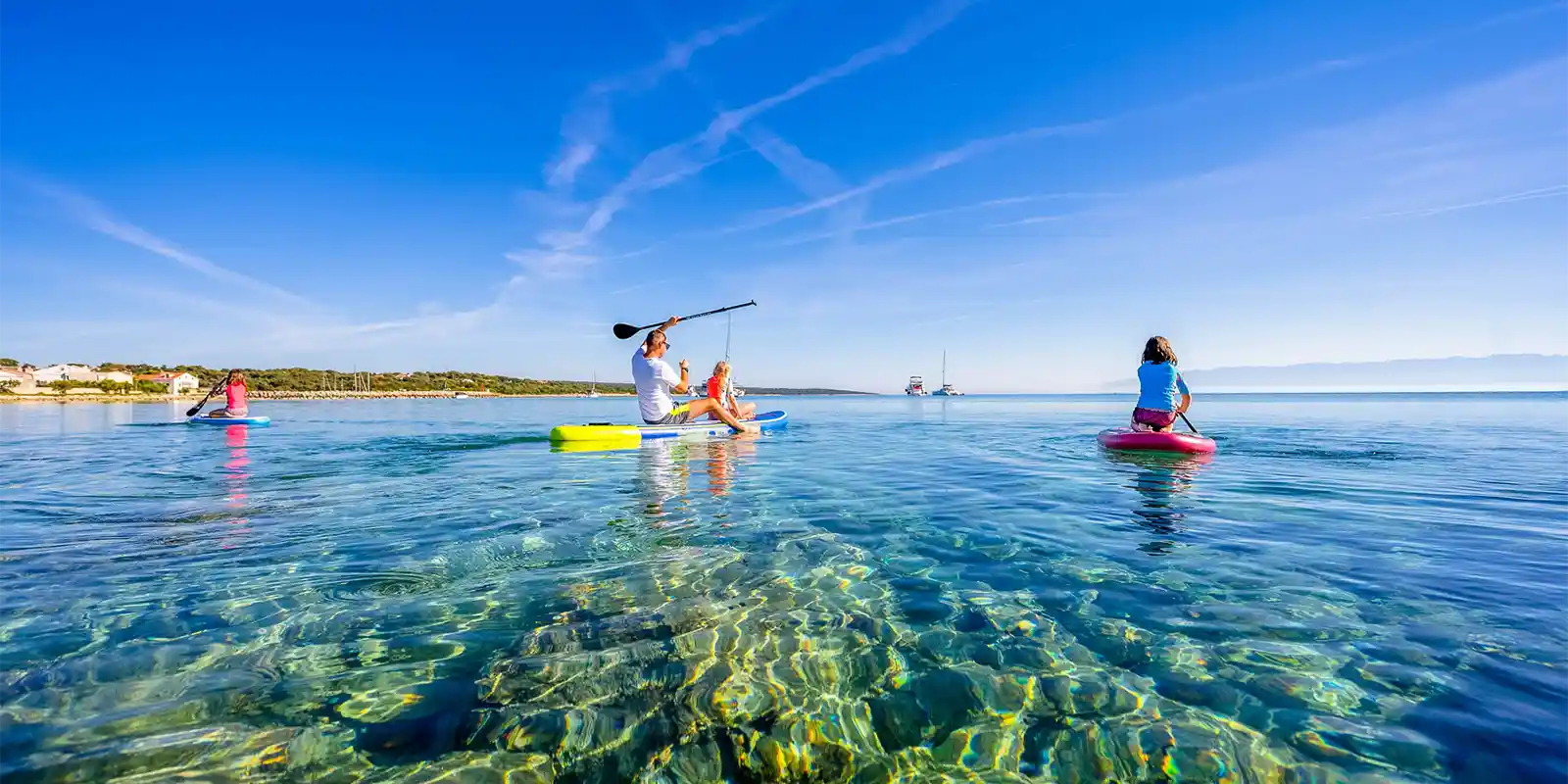 Family paddleboarding in Croatia