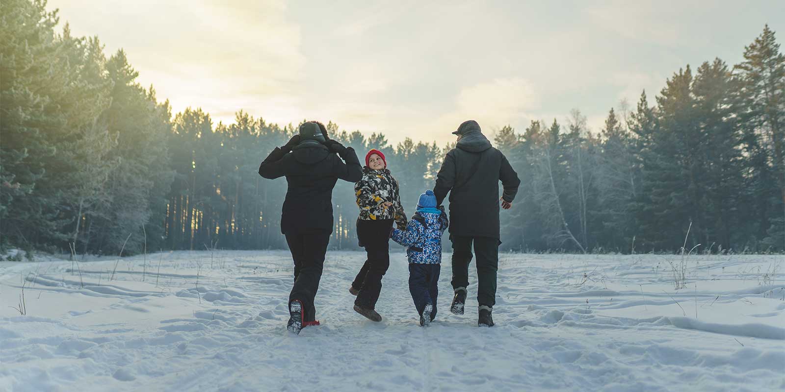 Family walking through snow in Finland