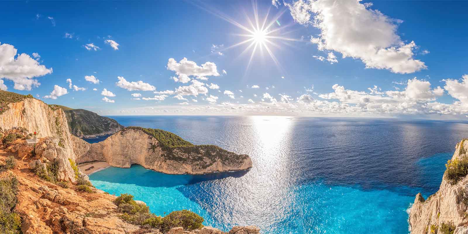 Turquoise bay and cliffs at sunset on Zakynthos island in Greece