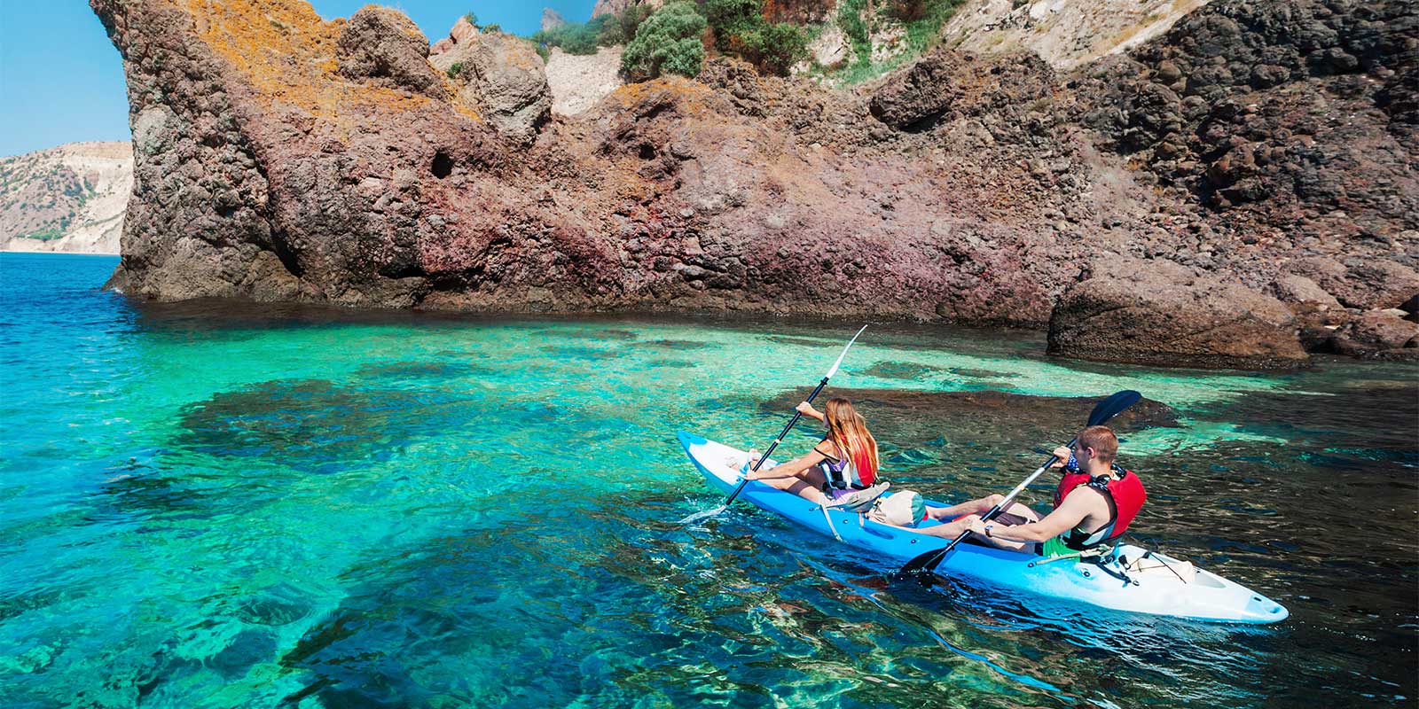 Young people kayaking around coastal waters in Turkey