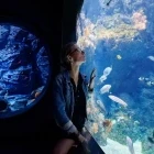 Young woman looking at fish in Singapore Oceanarium, Sentosa.