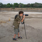 Young boy taking photographs whilst on safari in Zambia.