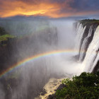 Sunset and rainbow over Victoria Falls in Zambia