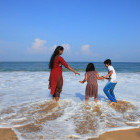 Family on the beach in Kovalam, Kerala, India