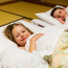 Children on traditional futons in Japan