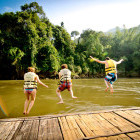 Children jumping into the River Kwai in Thailand.