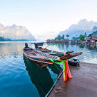 Long boats on Cheow Lan Lake in Thailand