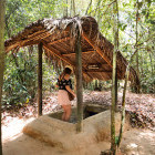 Girl entering a Cu Chi Tunnel in Vietnam