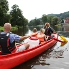 Family canoeing on the Jizerka River in Czech Republic