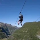 People ziplining in Flam, Norway.
