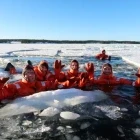 Guests floating in suits in a river - part of the Icebreaker cruise experience