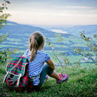 Young girl looking over the hillside in Austria