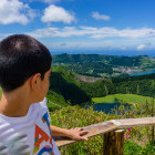 Young boy overlooking Sete Cidades in São Miguel Island, the Azores