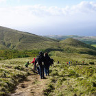 Group hiking past green hills on São Miguel Island, the Azores