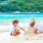 Siblings making sandcastles in Croatia