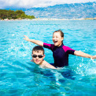 Siblings swimming in Croatia