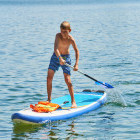 Boy stand-up paddleboarding in Crete, Greece
