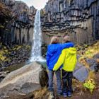 Siblings at waterfall in Skaftafell, Iceland