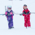 Two young girls carrying their ski equipment in Myrkdalen in Norway