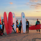 Group on the beach with their surf boards in Portugal