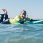 Parent learning to surf in Portugal
