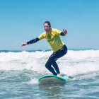 Parent learning to surf in Portugal
