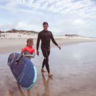 Young walking to sea during a surf lesson in Portugal