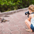 Girl and marine iguana in the Galapagos Islands