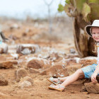 Girl with blue-footed booby in the Galapagos Islands