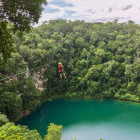 Girl ziplining over cenote in Mexico
