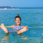 Girl floating in the Dead Sea, Jordan