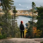 A hiker looking at the view from the Le Fjord Trail of Mont Adéla-Lessard, Canada.