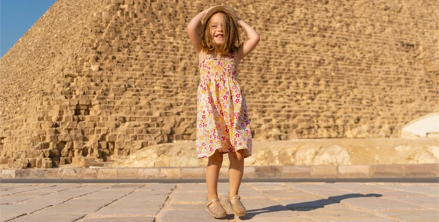 Girl in front of the Pyramids of Giza in Egypt