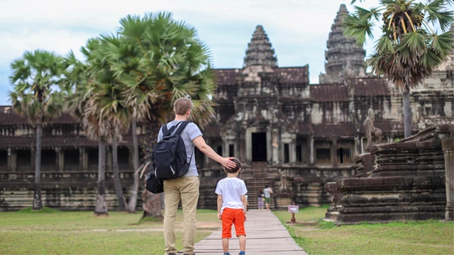 Father and son outside Angkor Wat in Siem Reap, Cambodia