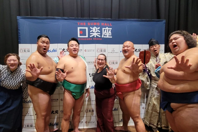 Travel consultant Jenny with some sumo wrestlers, in Japan.