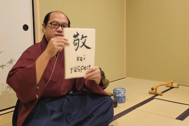 A Japanese man sharing part of the traditional tea ceremony.