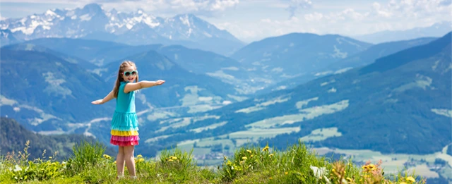 Young girl in Austria looking out to the mountains