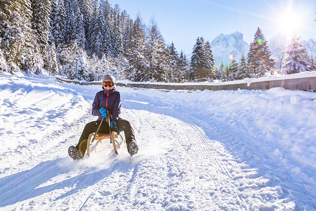 Girl sledging in Finland