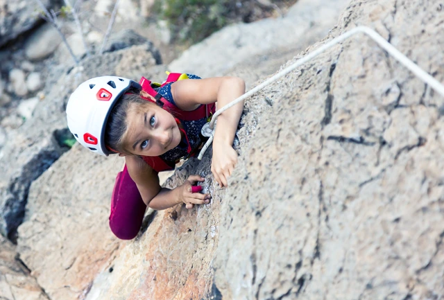Girl rock climbing on holiday