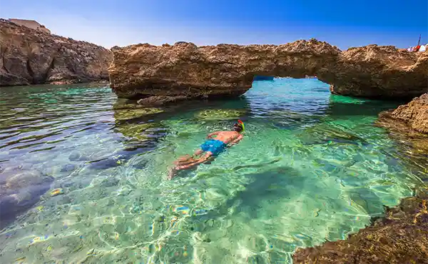 Person snorkelling in Gozo, Malta
