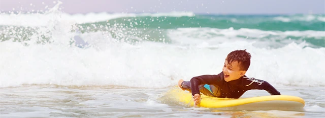 Boy surfing in Portugal