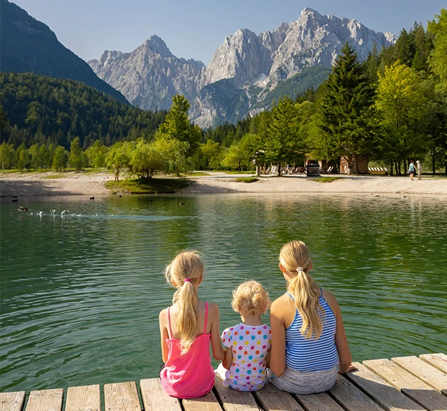 Siblings sitting on a baord walk in Triglav National Park, Slovenia