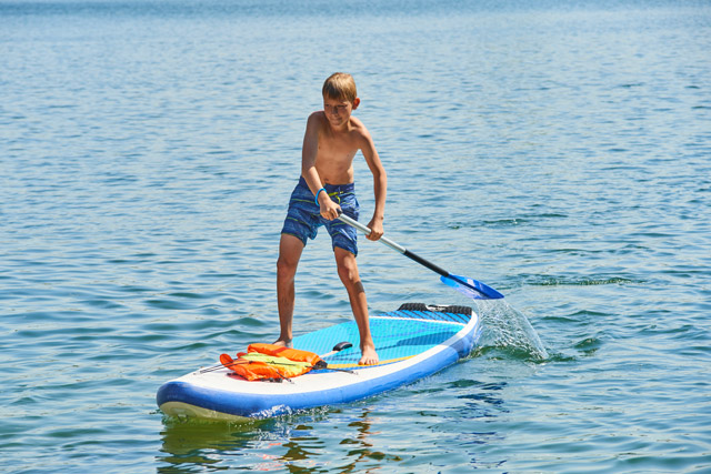 Boy stand-up paddleboarding