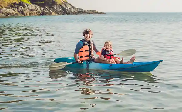 Father & son kayaking on holiday