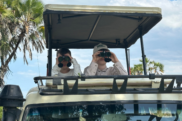 The Siddon family observing wildlife on safari, Tanzania.