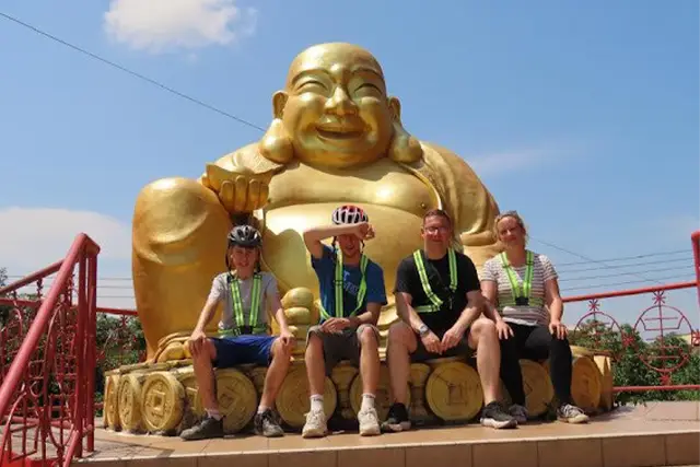 The Walker family in front of a giant buddha statue in Borneo.